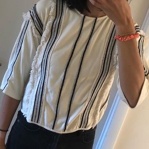 Anthropologie cream and black fringe top